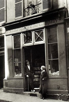 James Joyce and Sylvia Beach outside the door of Shakespeare and Company on the Rue de l'Odéon, black-and-white photograph, Paris 1920, unknown photographer; source: Poetry/Rare Books Collection, University Libraries, State University of New York at Buffalo, http://library.buffalo.edu/pl/.